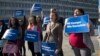 Activists with Planned Parenthood demonstrate in support of a pregnant 17-year-old being held in a Texas facility for unaccompanied immigrant children to obtain an abortion, outside of the Department of Health and Human Services in Washington, Oct. 20, 2017.