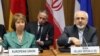 European Union foreign policy chief Catherine Ashton (L) and Iranian Foreign Minister Mohamad Javad Zarif (R) wait for the start of closed-door nuclear talks in Vienna, Austria, March 18, 2014.