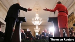 FILE - Britain's ambassador to the U.S. Kim Darroch listens as U.S. President Donald Trump and British Prime Minister Theresa May hold a joint news conference at the White House in Washington.