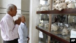 Survivors of the Khmer Rouge regime, Chum Mey (L) and Bou Meng (C) pray at Choeung Ek "Killing Fields" site located on the outskirts of Phnom Penh, June 25, 2011.