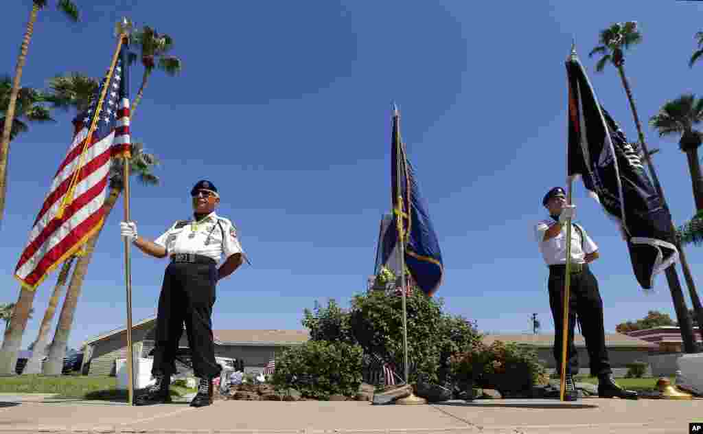 Members of the POW-MIA-KIA Honor Guard organization stand in front of a local mortuary keeping the late Arizona Sen. John McCain, Aug. 26, 2018, in Phoenix.