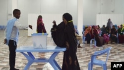 FILE - A woman casts her vote during Somalia's parliament election, at a polling station in Mogadishu, Somalia, Dec. 6, 2016.