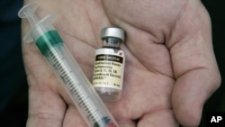 FILE - A doctor holds a vial of the human papillomavirus vaccine Gardasil. Namibian health authorities say they are set to begin distributing the HPV vaccine to adolescent girls in the southern Africa country.