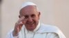 Pope Francis waves as he arrives to lead his Wednesday general audience in Saint Peter's Square at the Vatican, Sept. 18, 2013.
