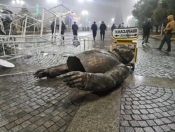 A monument to Nursultan Nazarbayev, demolished by protesters.
