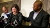 Former NFL player Dorsey Levens, right, extends a hand as Mary Ann Easterling, the widow of former NFL player Ray Easterling, reacts during a news conference, April 9, 2013, in Philadelphia, after a hearing to determine whether the NFL faces years of litigation over concussion-related brain injuries. 