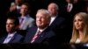 FILE - Donald Trump, then a Republican presidential candidate. watches with Donald Trump Jr., left, and Ivanka Trump as son Eric Trump addresses delegates during the Republican National Convention in Cleveland, July 20, 2016. 