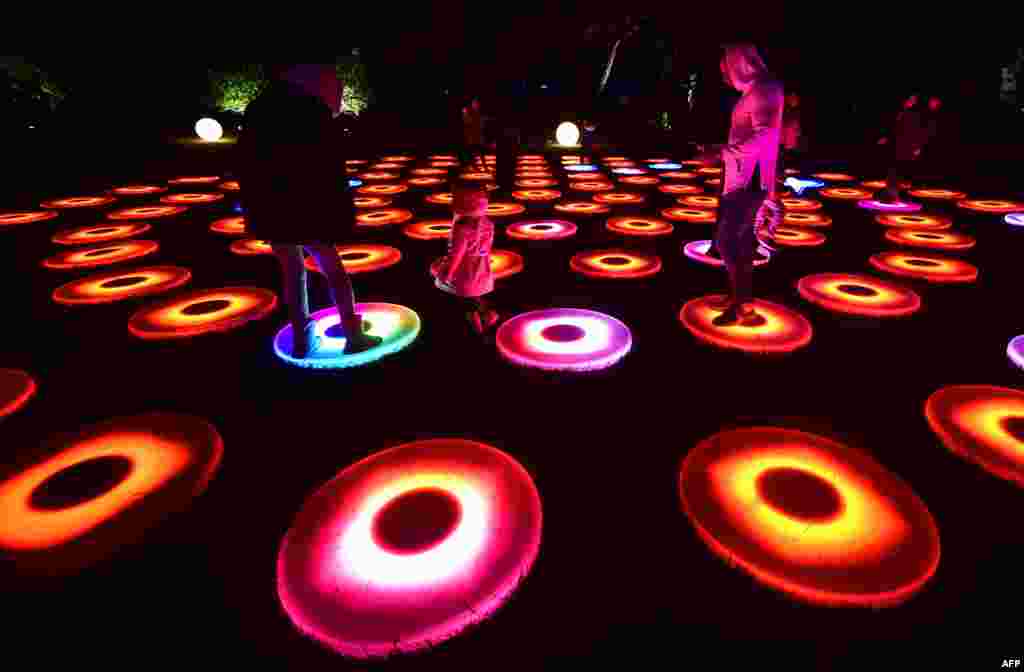 People visit the Enchanted Forest of Light preview at Descanso Gardens in La Canada Flintridge, California, Nov. 21, 2016, where Descanso's hallmark oak trees and botanical collections will be lit for 43 nights starting Nov. 25 to celebrate the festive season.