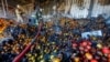 Firefighters stand on heaps of fruit while working inside burnt market stalls hit by shelling in the course of Russia-Ukraine conflict in Donetsk, Russian-controlled Ukraine, Dec. 6, 2022. 