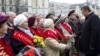Ukrainian President Viktor Yanukovich (R) greets veterans during a ceremony to mark the day of Ukraine's liberation from Nazi invaders during World War Two on the day of the parliamentary elections in Kiev, October 28, 2012.