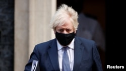 Britain's Prime Minister Boris Johnson leaves Downing Street, in London, Jan. 6, 2021.