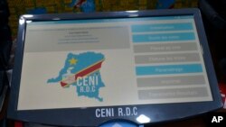 FILE - An example of the electronic voting machines that will be used for the next election is displayed during a demonstration with political agents in Kinshasa, Democratic Republic of the Congo, March 15, 2018. 