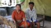 Keo Eat, 52, a deputy Prey Khla commune chief, decided to join the ruling Cambodian People’s Party after being served with a court summons shortly before the deadline to defect. He had been accused of incitement and faced the possibility of going to jail for two years if found guilty. He's shown with his wife, Keo Sarin. (Sun Narin/VOA Khmer)