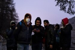 FILE - Kurdish migrants gather to organize their attempt to cross the French border in Claviere, Susa Valley, Alps Region, north-western Italy, Apr. 22, 2021.