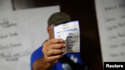 Un ciudadano muestra la boleta con su voto durante la primaria presidencial de la oposición.