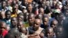 Striking miners gather gathered at the Wonderkop Stadium in Marikana as they wait for Association of Mine workers and construction Union's president Joseph Mathunjwa to address them on May 14, 2014 in Marikana, South Africa.