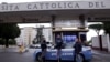 Police officers stand next to a car outside the Gemelli hospital where Pope Francis has gone to continue treatment for ongoing bronchitis in Rome, Feb. 14, 2025.