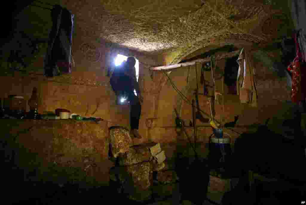 Sami, 32, steps into an underground Roman tomb used for shelter from Syrian government shelling and airstrikes, Jabal al-Zaweya, Idlib province, Syria, Feb. 28, 2013.