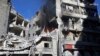 This image released by Thiqa News Agency shows smoke rising and fires still burning after airstrikes hit the Al-Shaar neighborhood of Aleppo, Syria, Friday, Nov. 18, 2016.
