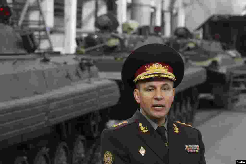 Ukraine's Defense Minister Valery Heletey speaks with journalists during his visit to the 141st Zhytomyr Armor Mechanical Repair Plant in Zhytomyr, Sept. 23, 2014.