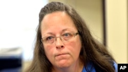 Rowan County Clerk Kim Davis listens to a customer following her office's refusal to issue marriage licenses at the Rowan County Courthouse in Morehead, Ky., Sept. 1, 2015. 