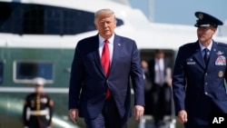 President Donald Trump boards Air Force One for a trip to Minnesota and Wisconsin, Aug. 17, 2020, in Andrews Air Force Base, Md.