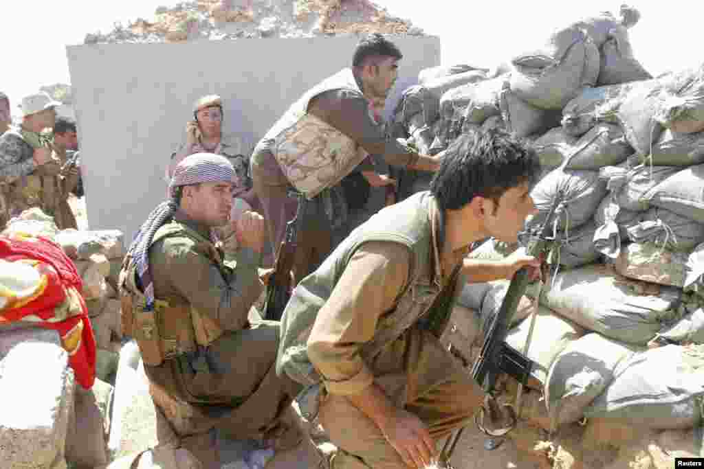 Kurdish peshmerga forces clash with Islamic State militants in the town of Daquq, south of Kirkuk, Sept. 30, 2014.