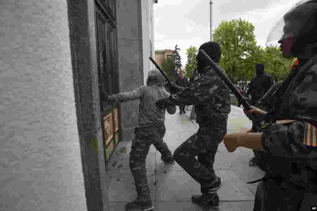 Pro-Russian activists storm an administration building in the center of Luhansk, Ukraine, one of the largest cities in Ukraine's troubled east, April 29, 2014.