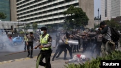 FILE - Police clash with protesters who gathered to rally against Indonesia's rule over the remote eastern Indonesian province of Papua, Dec. 1, 2015. Protesters and police faced off in Jakarta this year.