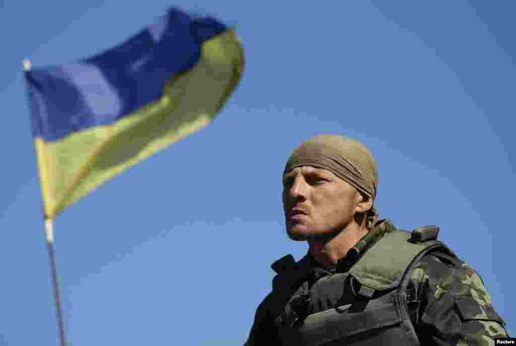 A Ukrainian serviceman stands at a checkpoint near the town of Horlivka in eastern Ukraine, Sept. 18, 2014.