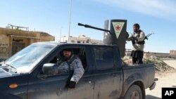 Popular Mobilization Forces (PMF) launch a rocket during clashes with Islamic State militants on the outskirts of the town of Hammam Al-Alil in south of Mosul, Iraq.