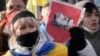 Ukrainians attend a rally in central Kyiv, Ukraine, Saturday, Feb. 12, 2022, during a protest against the potential escalation of the tension between Russia and Ukraine. 