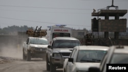 Turkey-backed Syrian rebel fighters return from the Syrian border town of Tal Abyad, as they are pictured on the Turkish-Syrian border in Akcakale, Turkey, Oct. 19, 2019.