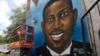 FILE - This May 17, 2020, photo shows a mural depicting Ahmaud Arbery in Brunswick, Ga.