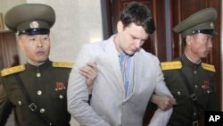 FILE - American student Otto Warmbier, center, is escorted at the Supreme Court in Pyongyang, North Korea, March 16, 2016. 