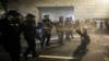 Demonstrators huddle and blow back tear gas with leaf blowers during clashes with federal officers during a police brutality protest at the Mark O. Hatfield United States Courthouse July 29, 2020, in Portland, Ore.