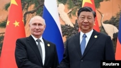 資料照片：2023 年10月18日，俄羅斯總統弗拉基米爾·普京在中國北京舉行的“一帶一路”論壇上與中國國家主席習近平握手。