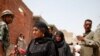 Voters check the registration lists on the second day of balloting. (Y. Weeks/VOA)