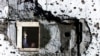 FILE - A worker repairs a war-shattered building at the former front line between two Bosnian entities in Sarajevo's suburb of Dobrinja, Nov. 20, 2000.