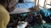 FILE - A medic takes care of a malnourished child with malaria in a hospital in Bor, South Sudan, March 15, 2014. 