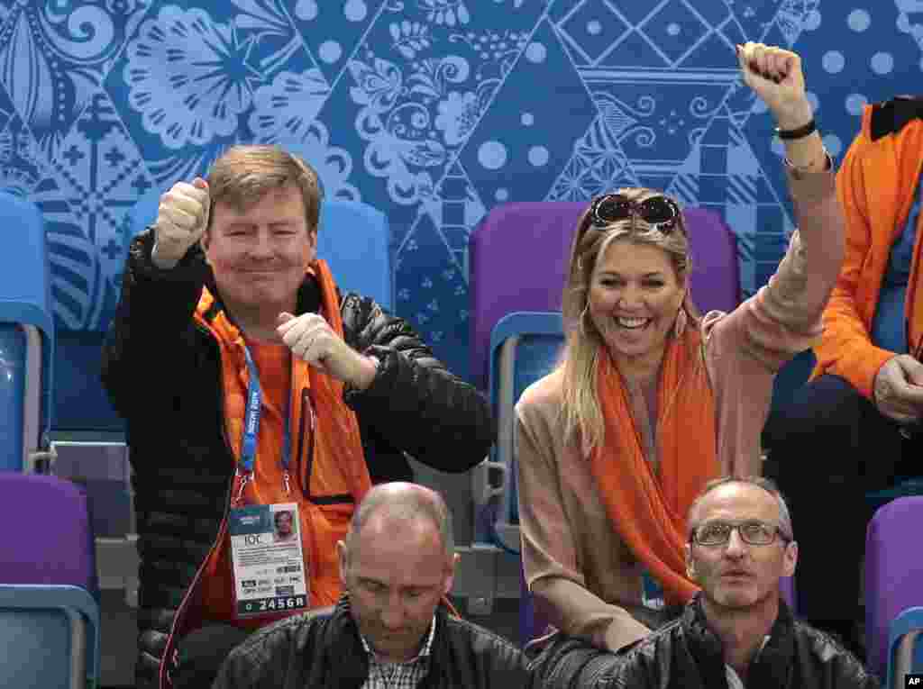 King Willem-Alexander of the Netherlands, back left, and Queen Maxima of the Netherlands, back right, cheer as they watch the men's 1500m short track speedskating heats at the Iceberg Skating Palace, Sochi, Russia, Feb. 10, 2014.