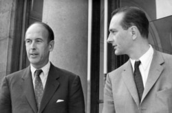FILE - Valery Giscard d'Estaing, left, as finance minister and Jacques Chirac as secretary of state to finance leave Elysee Palace, Aug. 9, 1969.