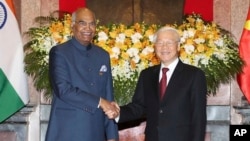 Indian President Ram Nath Kovind, left, shakes hands with Vietnamese President Nguyen Phu Trong before heading for talks behind closed doors in Hanoi, Vietnam, Tuesday, Nov. 20, 2018.