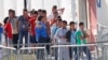 FILE - Children line up to enter a tent at the Homestead Temporary Shelter for Unaccompanied Children in Homestead, Fla., April 19, 2019. Immigrant advocates say the U.S. government is allowing migrant children to languish in “prisonlike conditions” instead of releasing them.