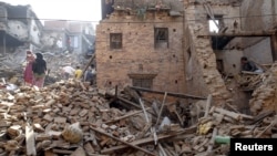 Local residents clear the rubble from their homes which were destroyed after last week's earthquake in Bhaktapur, Nepal, May 4, 2015.