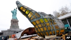 The original torch of the Statue of Liberty rests on a transporter, Nov. 15, 2018 in New York. The torch was being moved to a new museum on Liberty Island. 