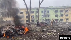 A view shows cars and a building of a hospital destroyed by an airstrike in Mariupol March 9, 2022. (Press service of the National Police of Ukraine/Handout via REUTERS)