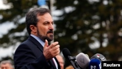 FILE- Syrian National Coalition spokesperson Louay Safi addresses the media after a meeting at the Geneva Conference on Syria, February 15, 2014.
