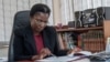 FILE - Martha Chizuma, then Malawi's ombudsman, works at her desk in her office in Lilongwe, Malawi, Sept. 9, 2019. 