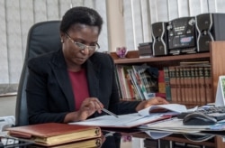FILE - Malawi Ombudsman Martha Chizuma works at her desk before giving an interview with Agence France-Presse in her office in Lilongwe, Malawi, Sept. 9, 2019.